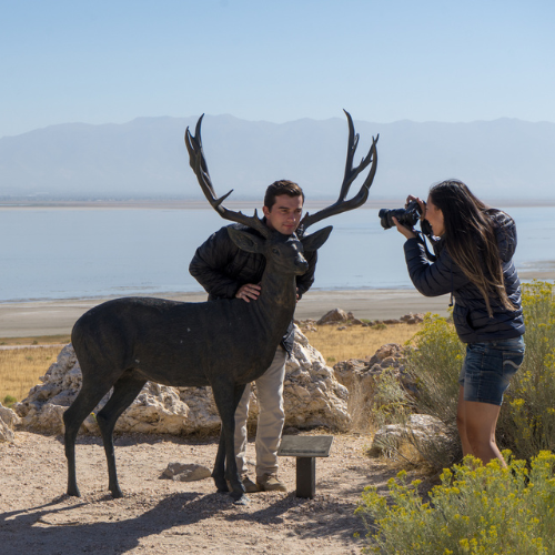Couple taking a picture on Antelope Island with statue