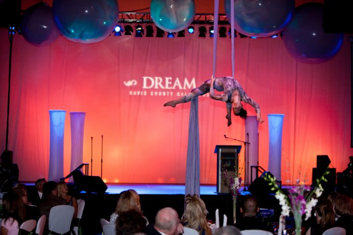 Acrobat hanging above stage Davis Conference Center