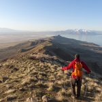 Hiker enjoying the view of the mountains and lake in Utah