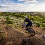 Mountain biker on Fruit Loops Trail with view of Davis County below
