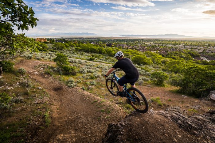 Mountain biker on Fruit Loops Trail with view of Davis County below
